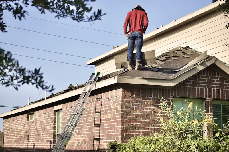Professional roofer working on a residential roof in Amboy